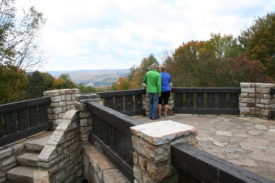 Couple on standing on top of the Stone Tower overlook at Allegany State Park