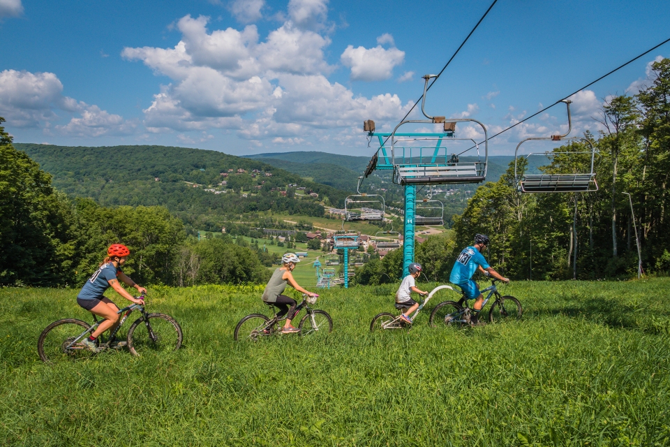 Mountain Biking family overlooking Holiday Valley Resort's base area (2021)