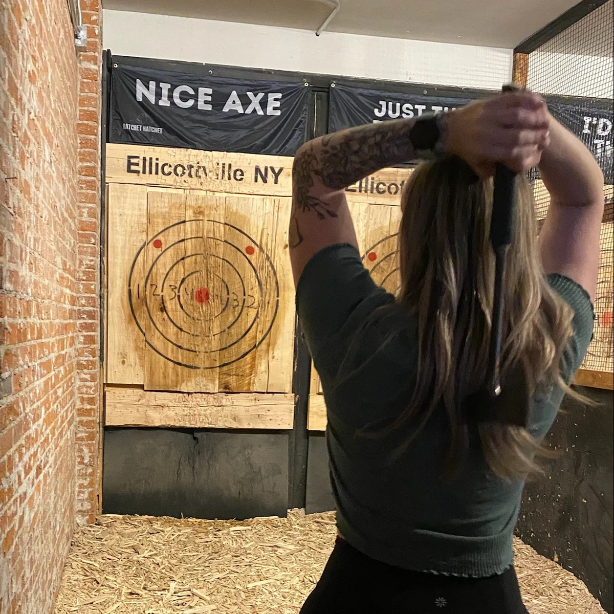 Woman throwing an axe at Ratchet Hatchet