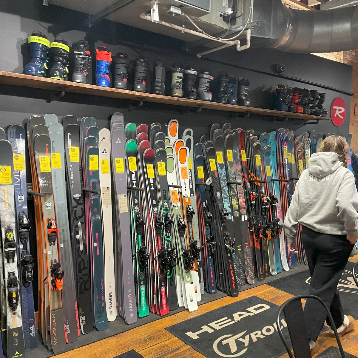 Shopper looking for new skis at Mud Sweat & Gears in Ellicottville