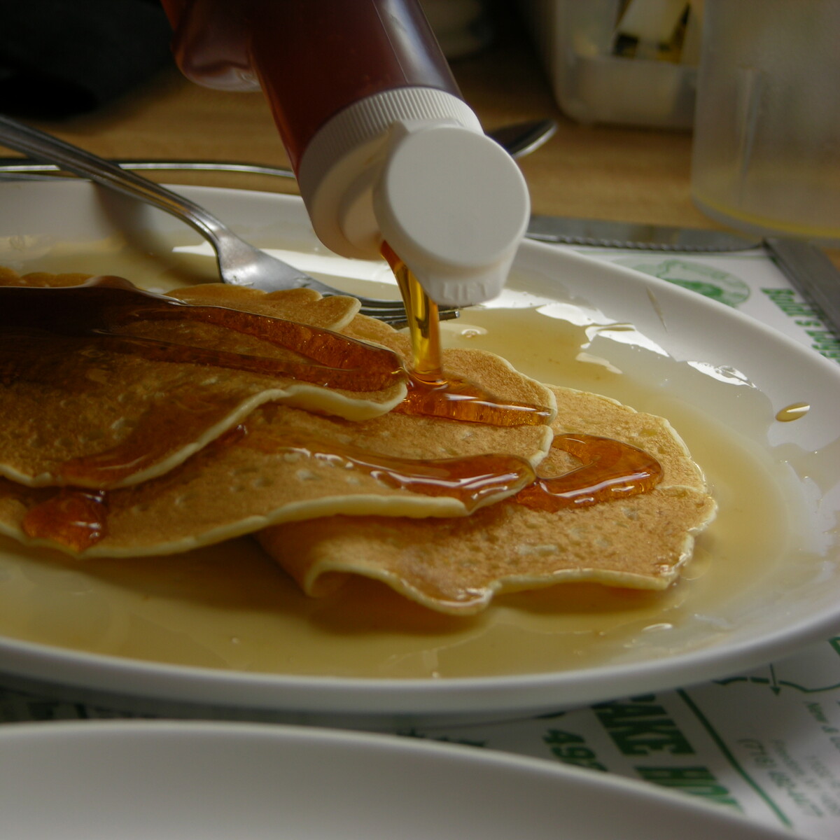 Maple syrup being poured on buttermilk pancakes at Moore's Maple Shack & Pancake House (2005)