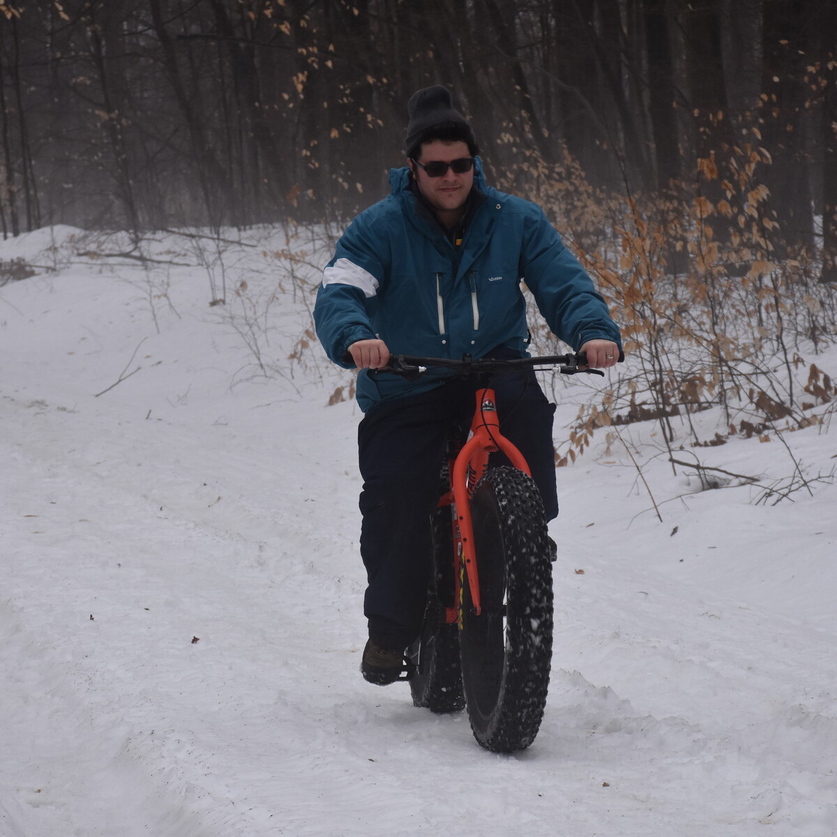 Man enjoying a ride on a fat bike in winter at Allegany State Park