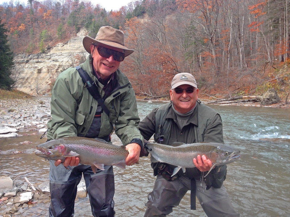 Two men holding fish caught in Catt creek