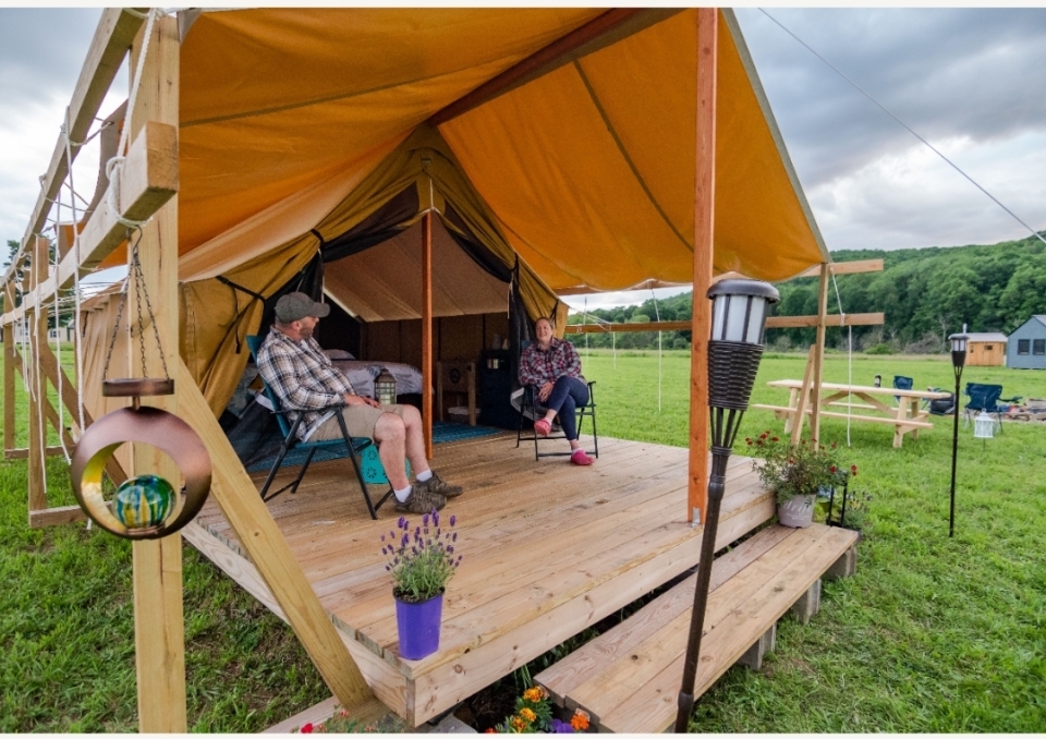 Campers at their tent at Good Natured Glamping