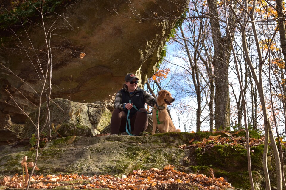 A hiker and their dog taking a break at Rock City Park