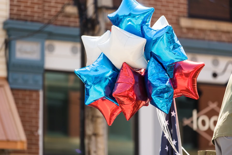 Red, white and blue balloons in a parade