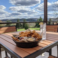 Food from Fairway View Pavilion with view of the Enchanted Mountains