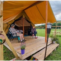 Campers at their tent at Good Natured Glamping