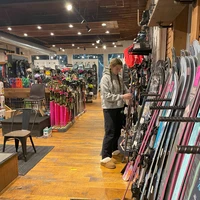 Shopper looking for new skis at Mud Sweat & Gears in Ellicottville
