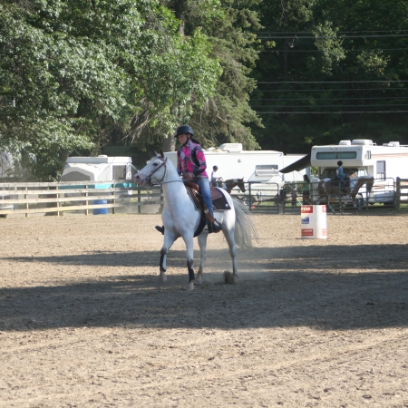 Girl riding horse at fairgound
