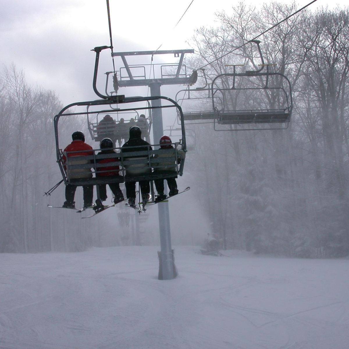 Group riding up the chairlift at HoliMont