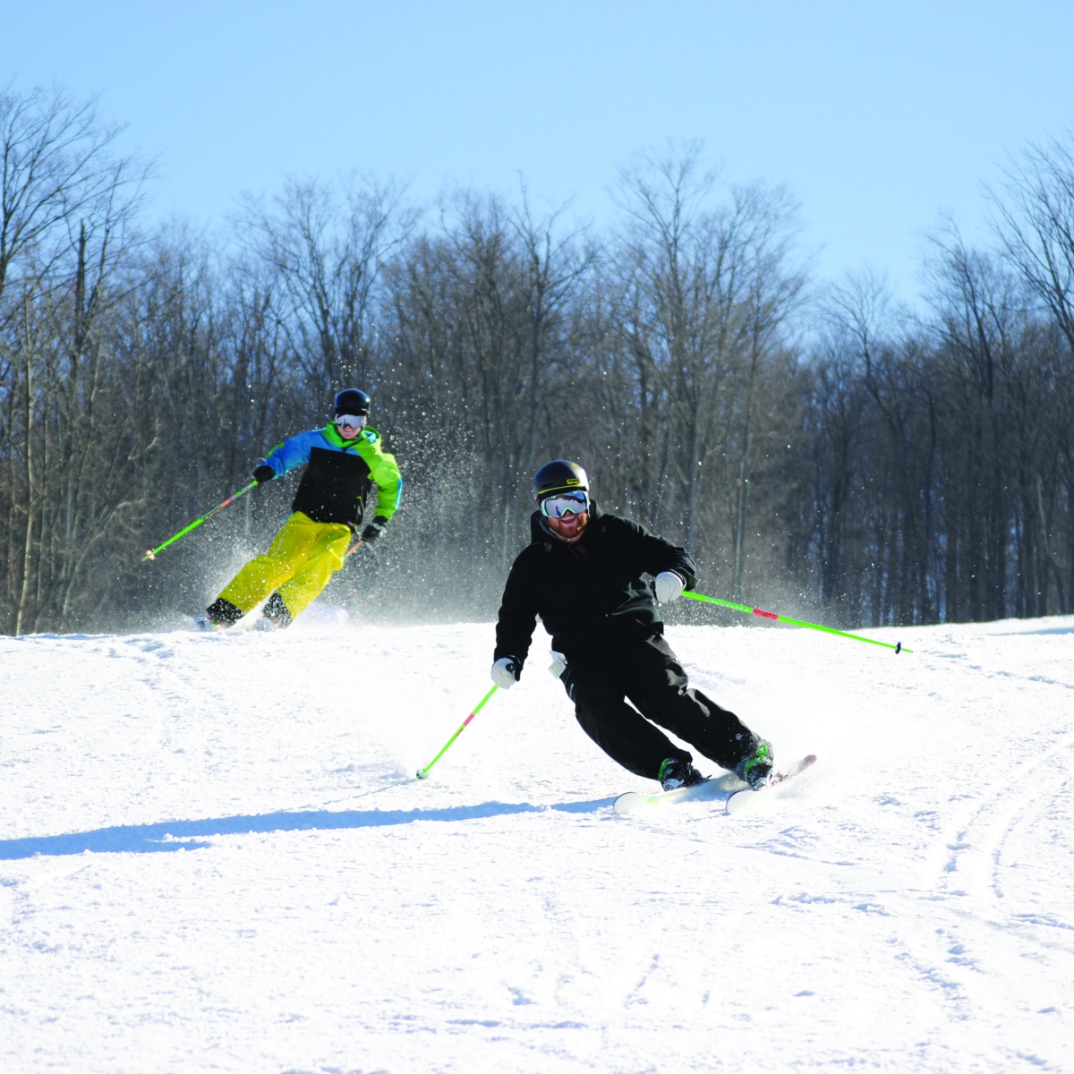 Skiers speeding downhill at HoliMont