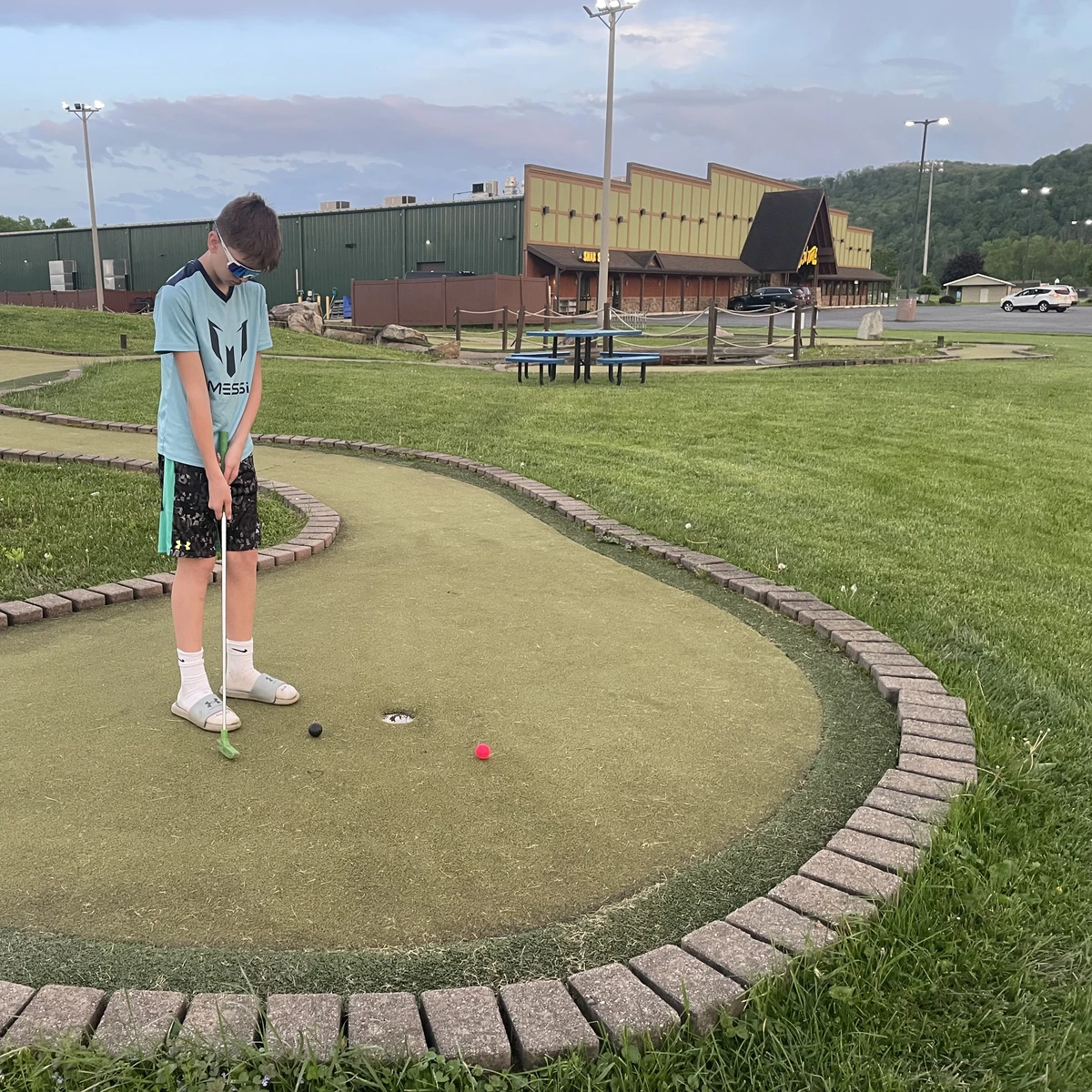 Boy playing putt putt at Good Times of Olean 