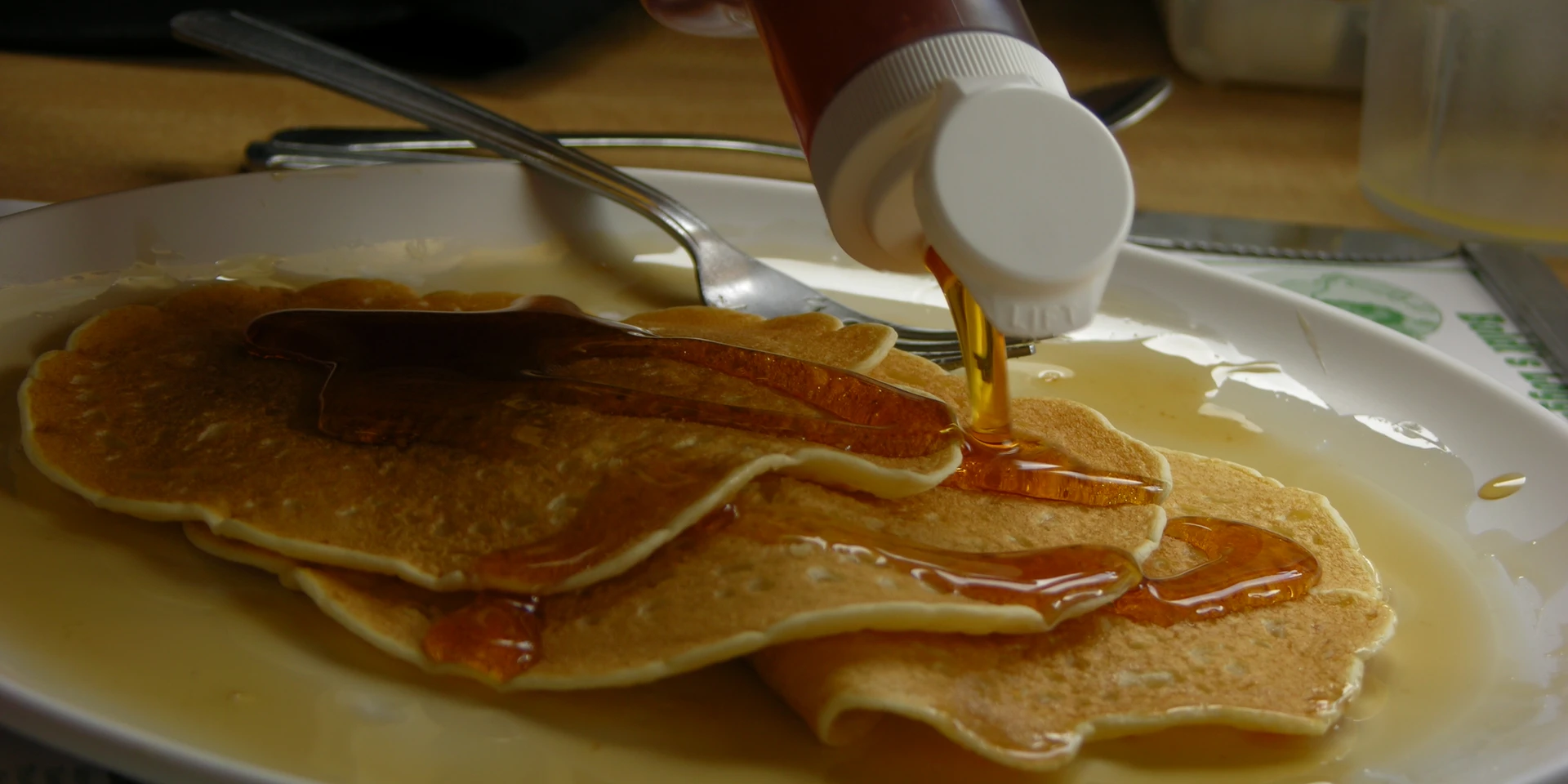Maple syrup being poured on buttermilk pancakes at Moore's Maple Shack & Pancake House (2005)
