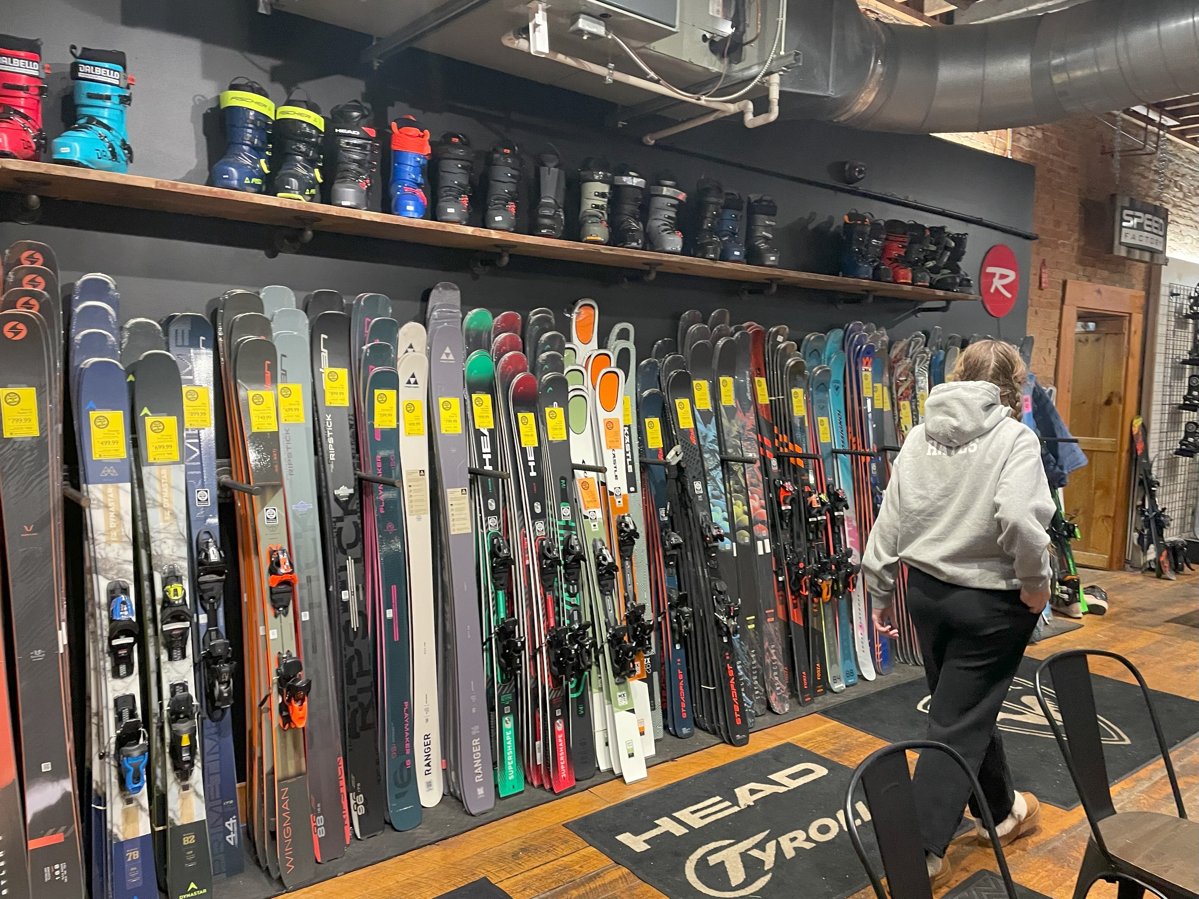 Shopper looking for new skis at Mud Sweat & Gears in Ellicottville