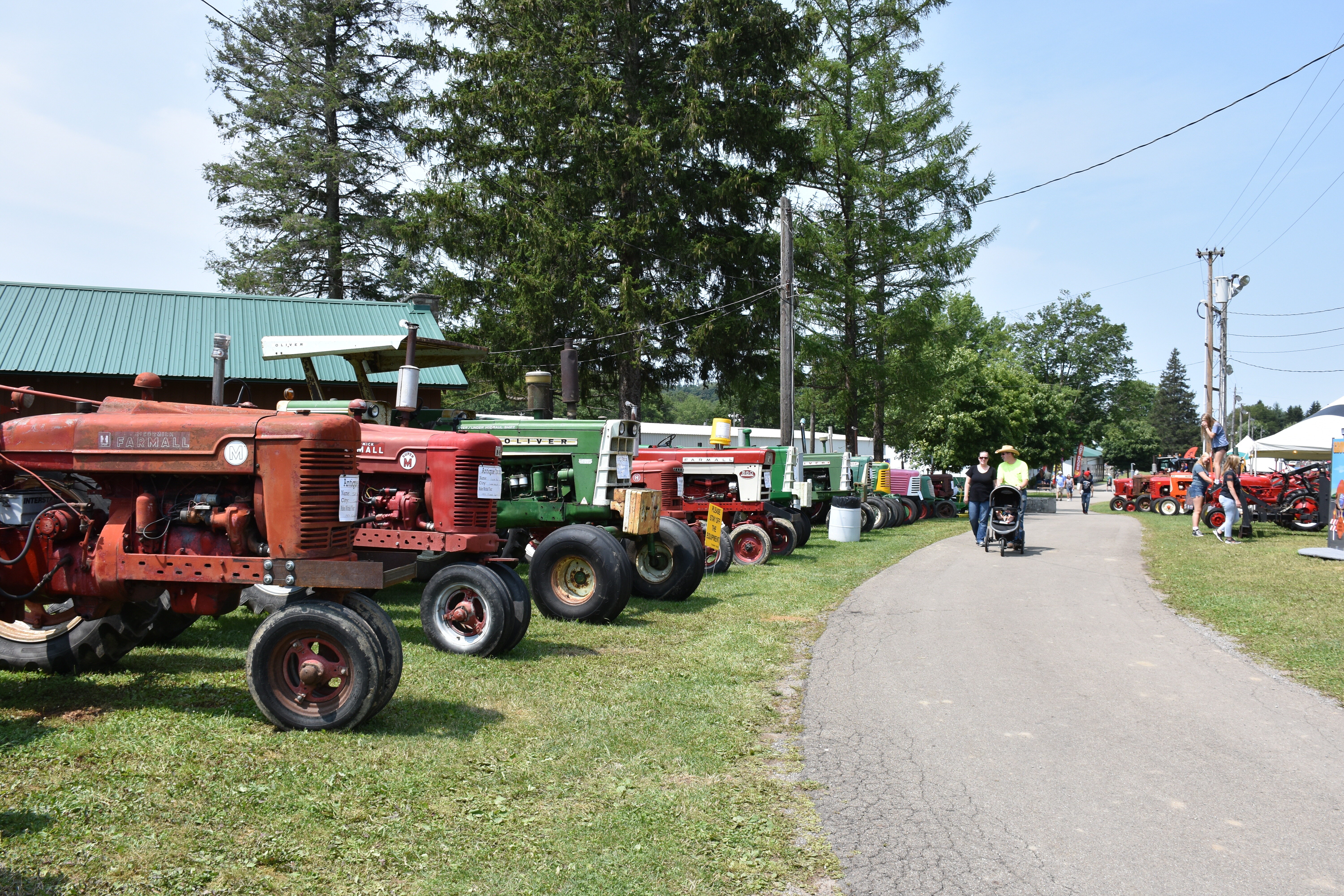 Family admiring the tractors at the 2023 Cattaraugus County Fair