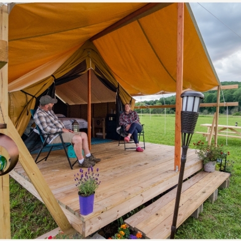 Campers at their tent at Good Natured Glamping