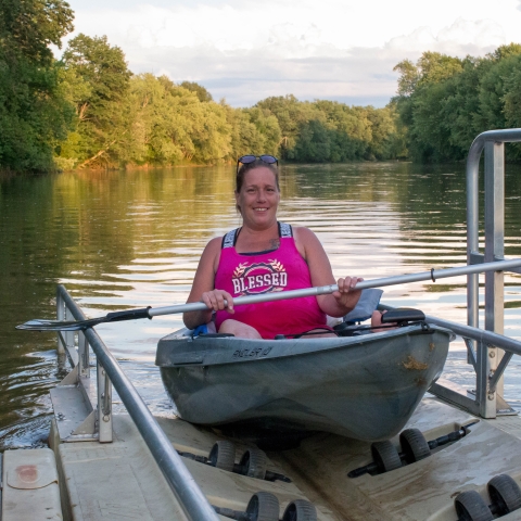 Woman using the handicap accessible boat launch at Allegany River Park