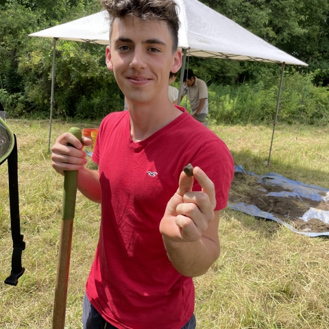 Volunteer holds 800 yr old ceramic pipe at Canticle Farms