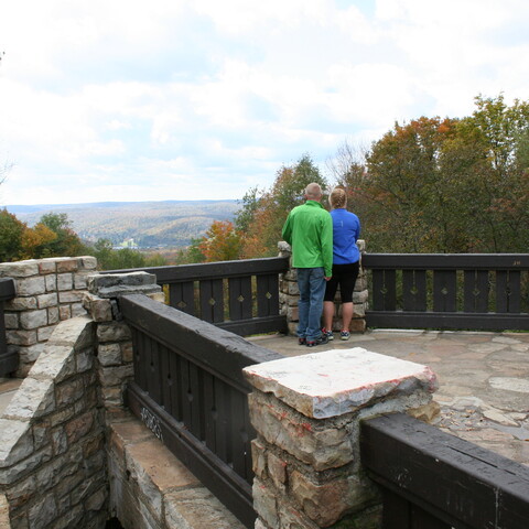Couple on standing on top of the Stone Tower overlook at Allegany State Park