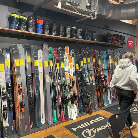 Shopper looking for new skis at Mud Sweat & Gears in Ellicottville