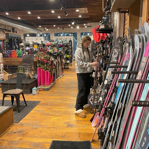 Shopper looking for new skis at Mud Sweat & Gears in Ellicottville