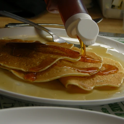 Maple syrup being poured on buttermilk pancakes at Moore's Maple Shack & Pancake House (2005)