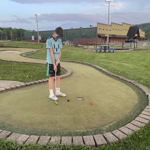 Boy playing putt putt at Good Times of Olean 