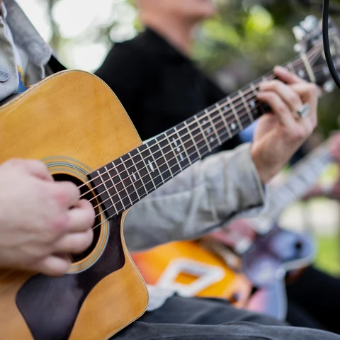 Adobe stock image- hands on a guitar
