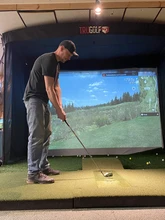 Golfer using the simulator