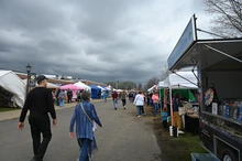 People walking by vendor and exhibitor booths at the WNY Maple Festival (Sunday 2024) at the Franklinville Elementary School - 0463