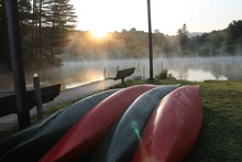 Canoes in rest on the shores of Red House Lake